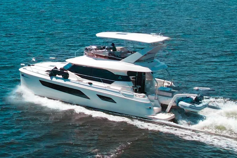 Ryan's Inheritance Yacht Photos Pics Aquila 44 Yacht 2017 cruising on open water, showcasing sleek design and luxury features.