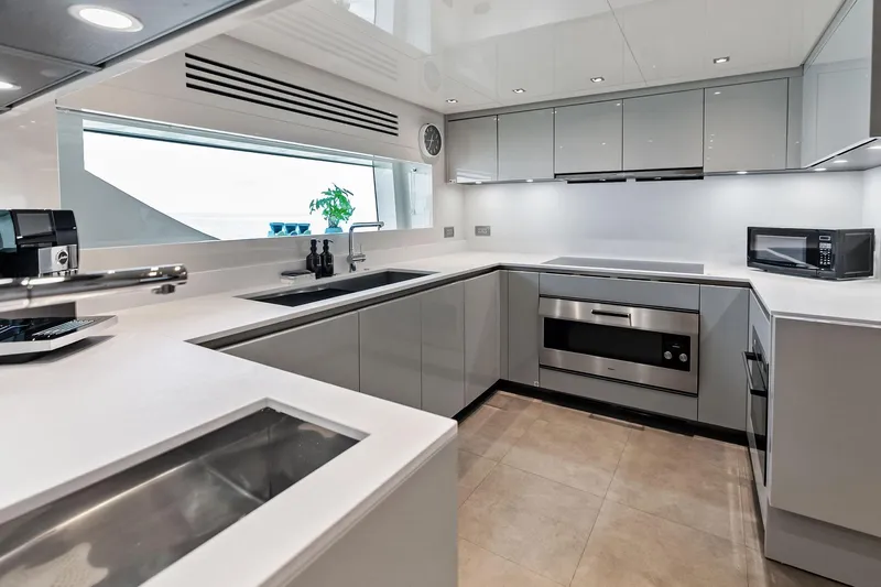 Glory Yacht Photos Pics Modern kitchen interior on 2023 Sanlorenzo SD126 yacht, featuring sleek cabinetry and appliances.
