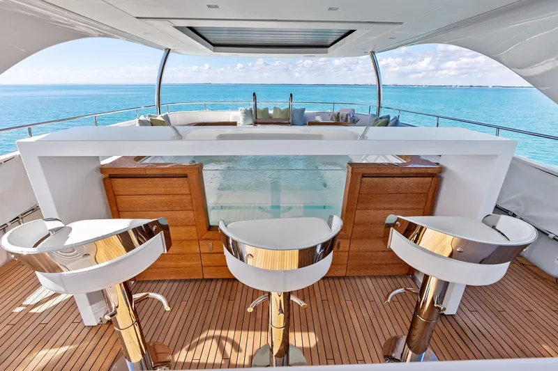 Glory Yacht Photos Pics Luxurious 2023 Sanlorenzo SD126 yacht deck with bar stools and ocean view.