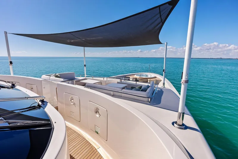 Glory Yacht Photos Pics Luxurious 2023 Sanlorenzo SD126 yacht deck with sunshade, overlooking serene ocean waters.