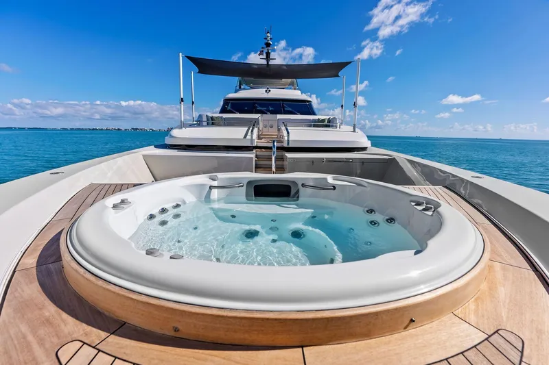 Glory Yacht Photos Pics Luxurious 2023 Sanlorenzo SD126 yacht with jacuzzi on deck, cruising in clear blue waters.
