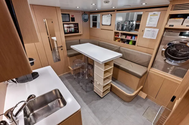 Glory Yacht Photos Pics Modern interior of 2023 Sanlorenzo SD126 yacht with kitchen and seating area.