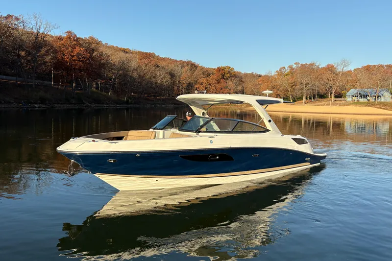  Yacht Photos Pics 2016 Sea Ray 350 SLX boat cruising on a calm lake with autumn trees.