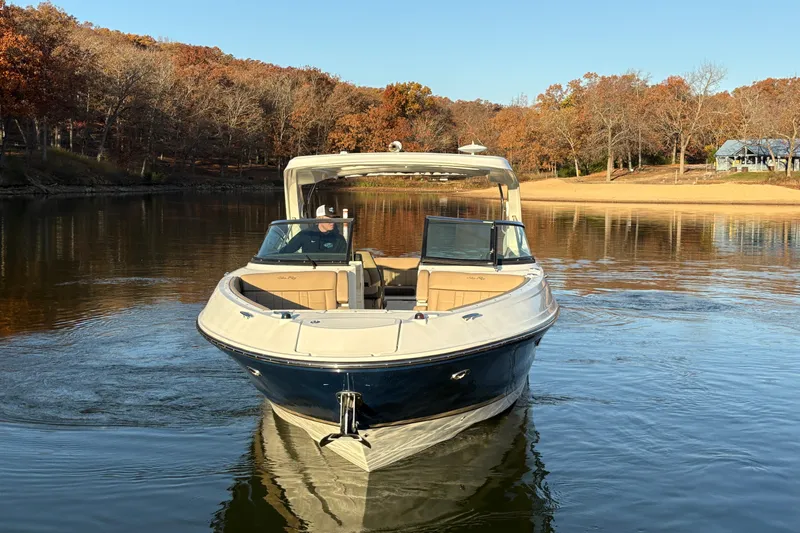  Yacht Photos Pics 2016 Sea Ray 350 SLX boat cruising on a calm lake with autumn trees.