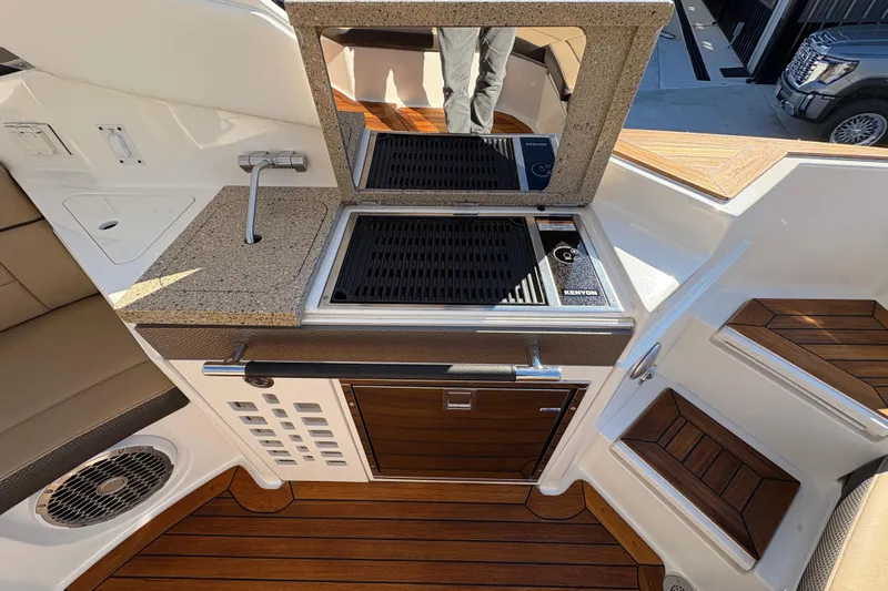  Yacht Photos Pics Luxurious 2016 Sea Ray 350 SLX boat interior with kitchenette and wooden flooring.
