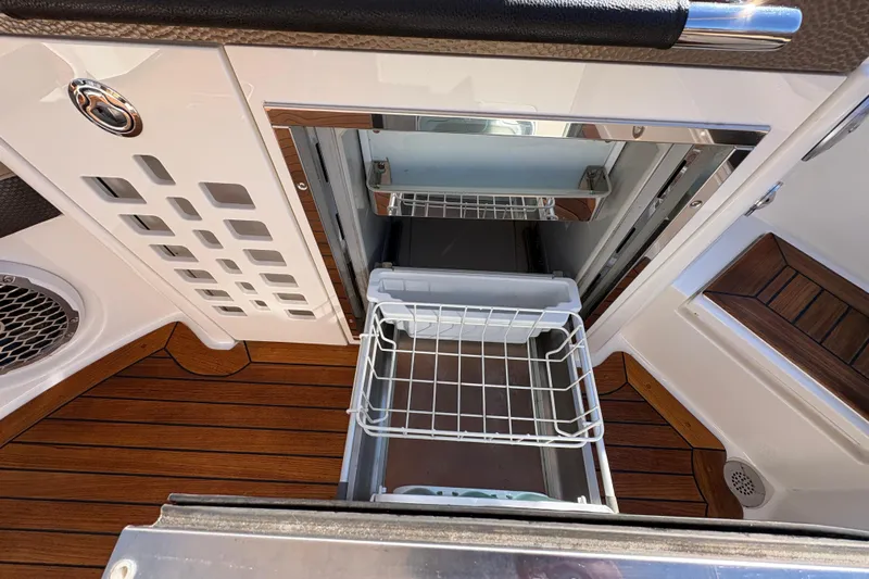  Yacht Photos Pics 2016 Sea Ray 350 SLX boat interior with open storage compartment and wooden flooring.