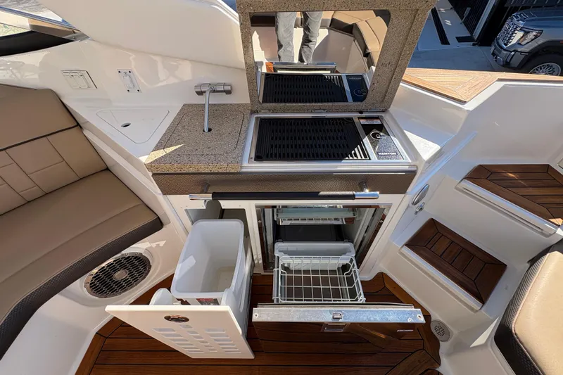  Yacht Photos Pics Interior of 2016 Sea Ray 350 SLX boat with kitchenette and seating area.