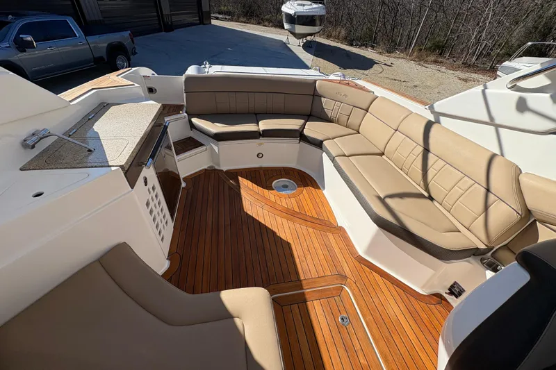  Yacht Photos Pics Luxurious 2016 Sea Ray 350 SLX boat interior with tan seating and wooden flooring.