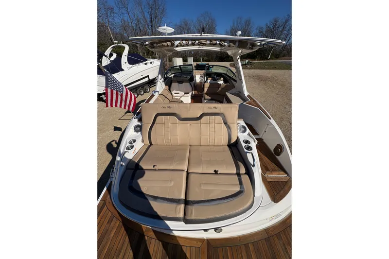 Yacht Photos Pics 2016 Sea Ray 350 SLX boat with tan seating and American flag, docked outdoors.