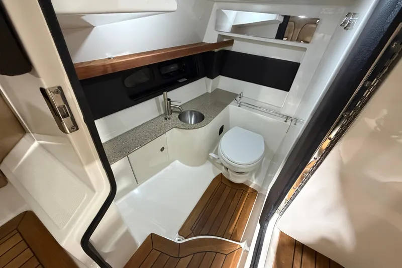  Yacht Photos Pics Luxurious 2016 Sea Ray 350 SLX boat bathroom with modern amenities and wooden accents.
