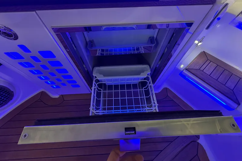  Yacht Photos Pics 2016 Sea Ray 350 SLX boat interior with illuminated storage compartment and wooden flooring.