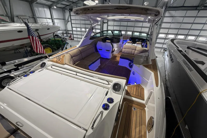  Yacht Photos Pics 2016 Sea Ray 350 SLX boat interior with seating and blue accent lighting in a garage.