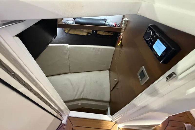  Yacht Photos Pics Interior cabin of 2016 Sea Ray 350 SLX boat with seating and control panel.