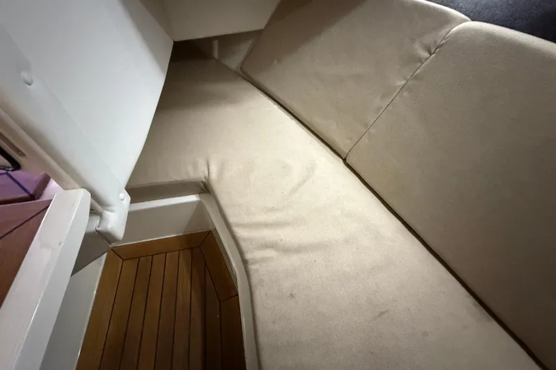  Yacht Photos Pics Interior cabin of 2016 Sea Ray 350 SLX with beige seating and wooden flooring.