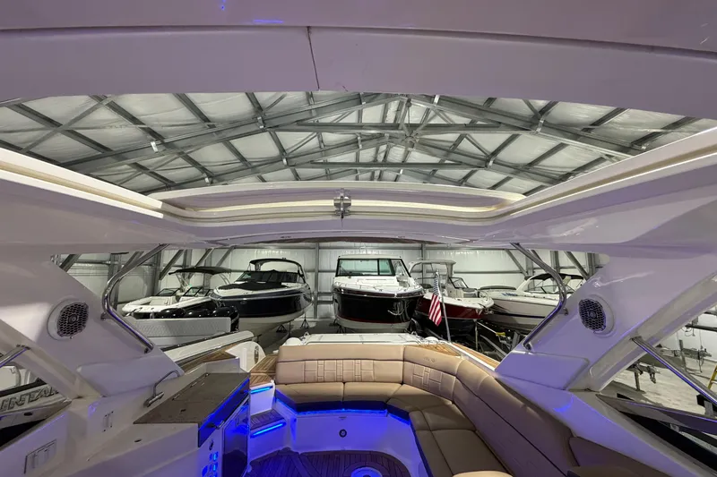  Yacht Photos Pics 2016 Sea Ray 350 SLX boat interior in a storage facility with other boats.