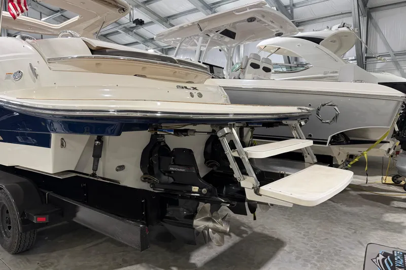  Yacht Photos Pics 2016 Sea Ray 350 SLX boat in a showroom, featuring a swim platform and outboard motor.
