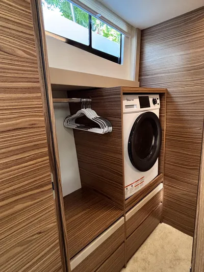 Micky's Dream Yacht Photos Pics Laundry area in 2020 Greenline 45 Fly yacht with washer and wooden cabinetry.