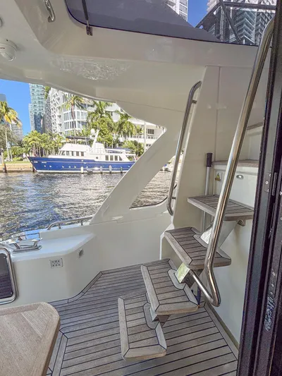 Micky's Dream Yacht Photos Pics Interior view of 2020 Greenline 45 Fly yacht with modern staircase and waterfront backdrop.