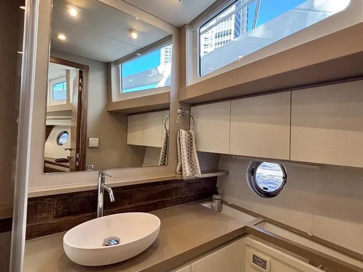 Micky's Dream Yacht Photos Pics Luxurious bathroom interior of 2020 Greenline 45 Fly yacht with modern fixtures and porthole.