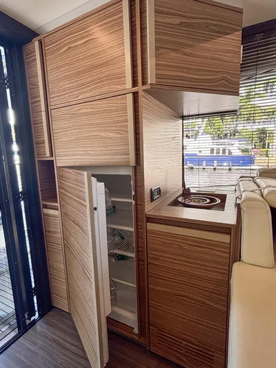 Micky's Dream Yacht Photos Pics Modern kitchen interior of 2020 Greenline 45 Fly yacht with wood finish and open fridge.