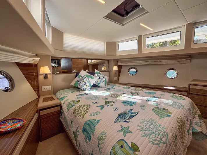 Micky's Dream Yacht Photos Pics Luxurious 2020 Greenline 45 Fly yacht bedroom with nautical-themed bedding and modern decor.