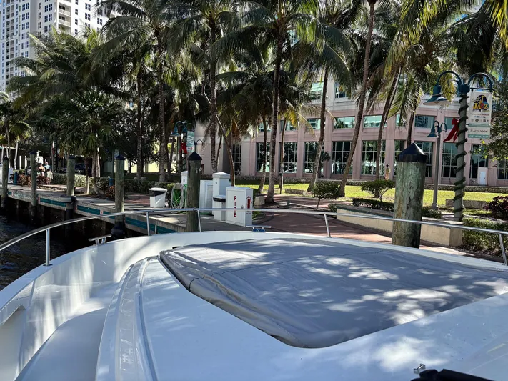 Micky's Dream Yacht Photos Pics 2020 Greenline 45 Fly yacht docked near palm trees and modern buildings.