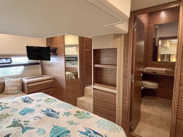 Micky's Dream Yacht Photos Pics Luxurious interior of 2020 Greenline 45 Fly yacht with wood paneling and marine-themed bedding.