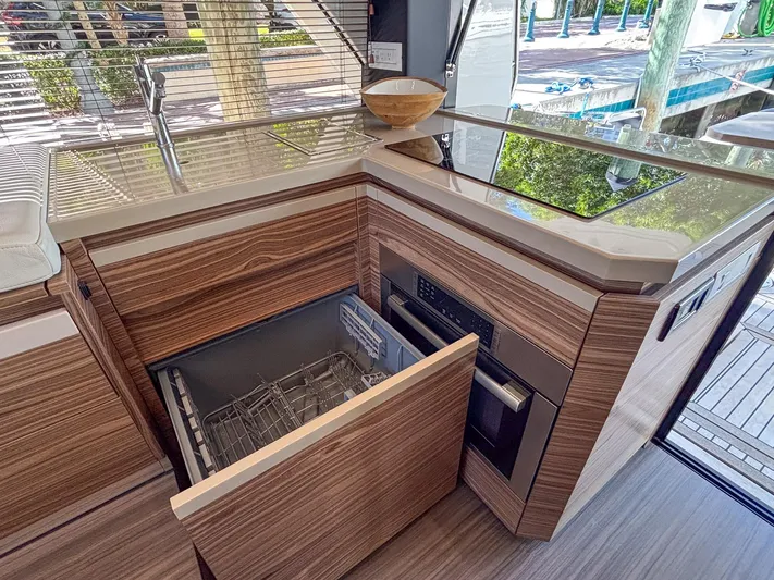 Micky's Dream Yacht Photos Pics Modern kitchen in 2020 Greenline 45 Fly yacht with wood cabinetry and open dishwasher.