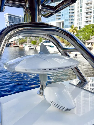 Micky's Dream Yacht Photos Pics TV antenna on a 2020 Greenline 45 Fly yacht, docked near modern buildings.