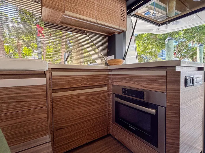 Micky's Dream Yacht Photos Pics Modern kitchen interior of 2020 Greenline 45 Fly yacht with wood cabinetry and appliances.