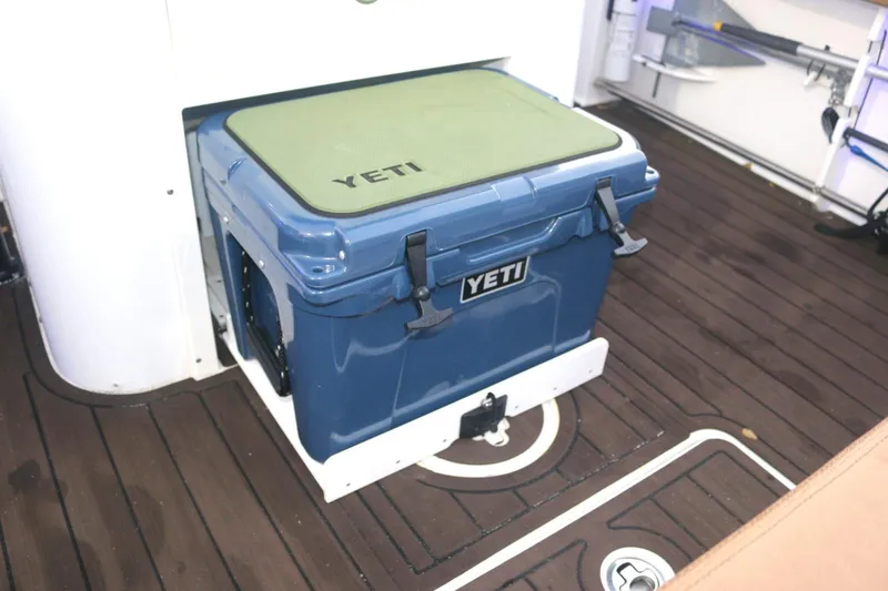  Yacht Photos Pics YETI cooler on 2022 Sea Hunt Ultra 305 SE boat deck, featuring wood flooring.