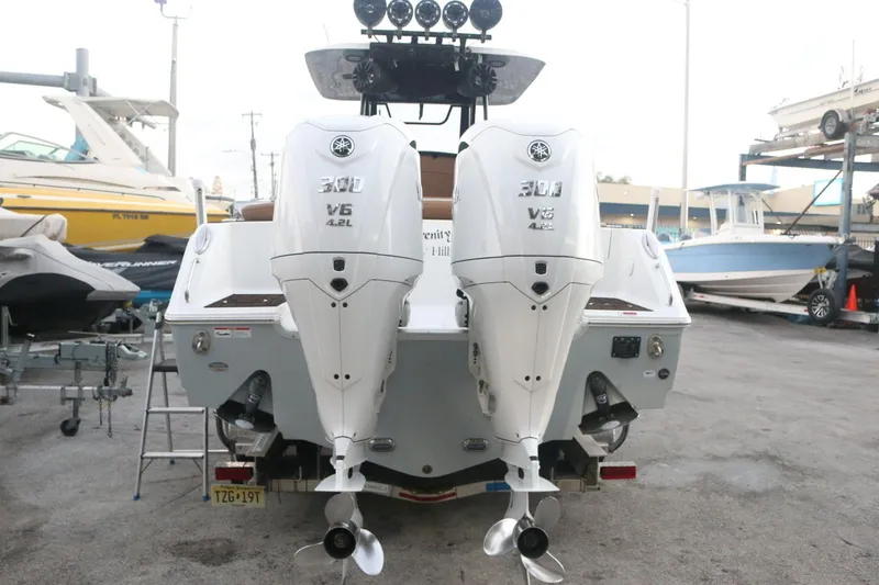  Yacht Photos Pics 2022 Sea Hunt Ultra 305 SE with twin Yamaha V6 outboard engines, docked at a marina.
