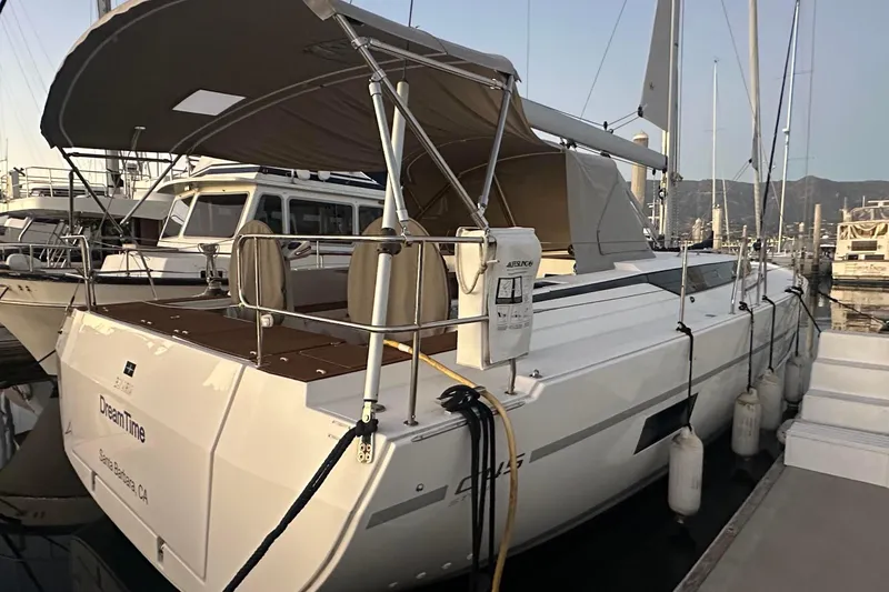 Dream Time Yacht Photos Pics 2022 Bavaria C45 yacht docked, featuring a shaded deck and sleek design.