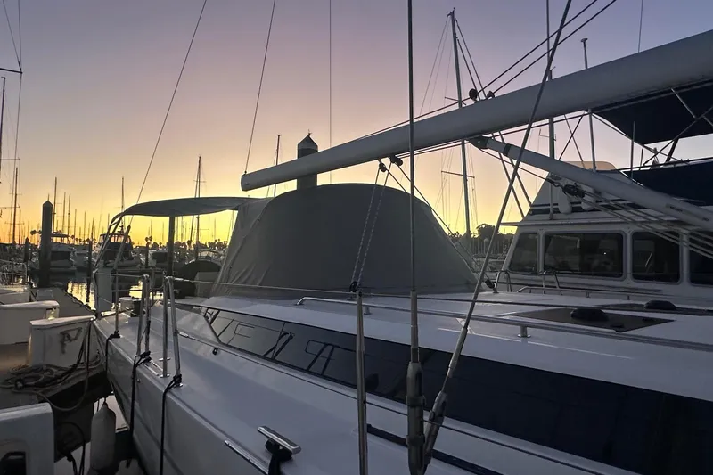Dream Time Yacht Photos Pics 2022 Bavaria C45 yacht docked at sunset, with masts silhouetted against the sky.