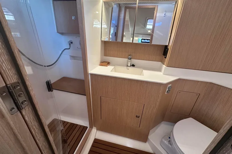 Dream Time Yacht Photos Pics Modern bathroom interior of 2022 Bavaria C45 yacht with wood accents and sleek fixtures.