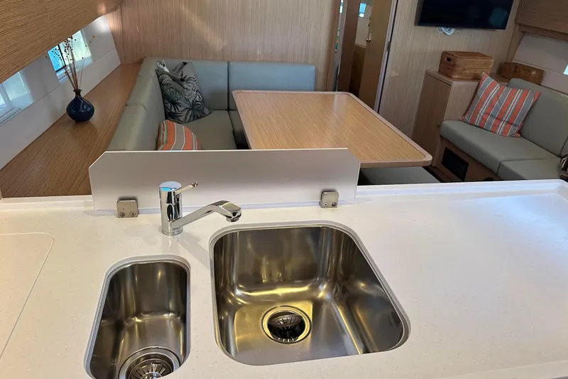 Dream Time Yacht Photos Pics Modern Bavaria C45 yacht interior with sleek kitchen sink and cozy seating area, 2022 model.