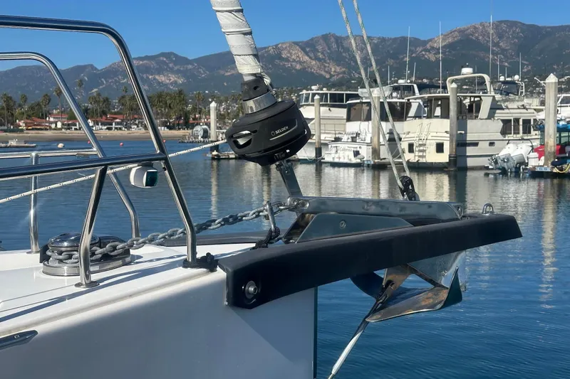 Dream Time Yacht Photos Pics Bavaria C45 yacht anchored in marina, 2022 model, with scenic mountain backdrop.