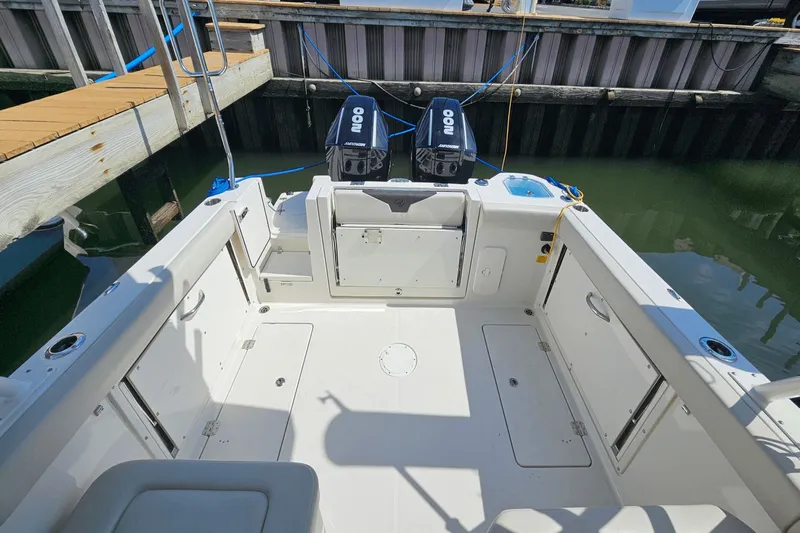  Yacht Photos Pics 2023 Sailfish 276 DC boat interior with dual engines at dock.