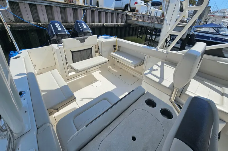  Yacht Photos Pics 2023 Sailfish 276 DC boat interior with seating and dual outboard motors.