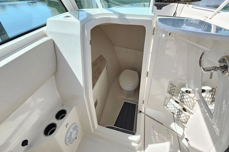  Yacht Photos Pics 2023 Sailfish 276 DC boat interior with compact bathroom and toilet.