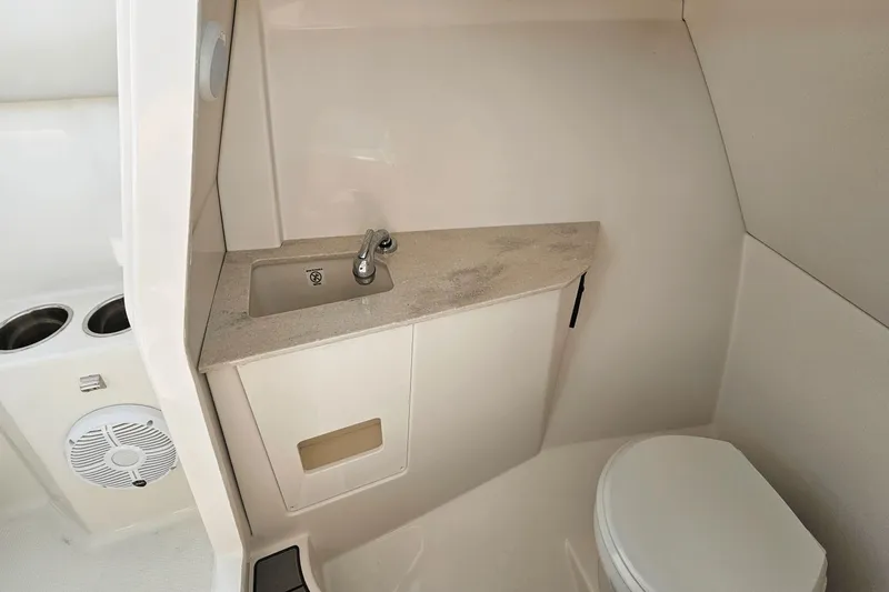  Yacht Photos Pics 2023 Sailfish 276 DC boat interior with sink and toilet.