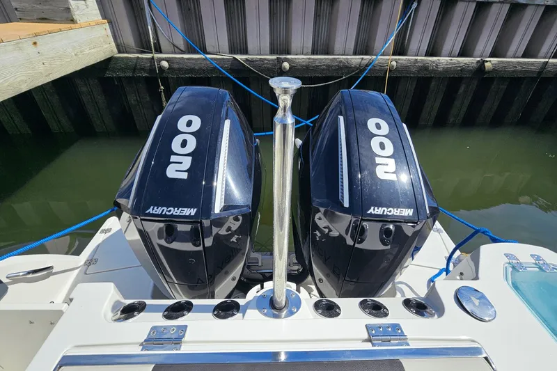  Yacht Photos Pics 2023 Sailfish 276 DC boat with dual Mercury 200 engines docked at marina.