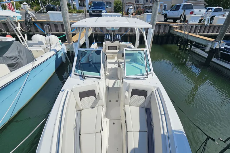  Yacht Photos Pics 2023 Sailfish 276 DC boat docked at marina, featuring spacious seating and modern design.