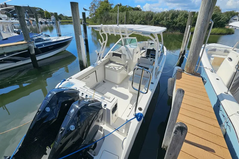  Yacht Photos Pics 2023 Sailfish 276 DC boat docked with dual engines, white interior, and canopy.