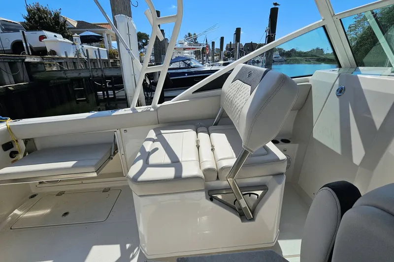  Yacht Photos Pics 2023 Sailfish 276 DC boat interior with cushioned seating and sleek design.