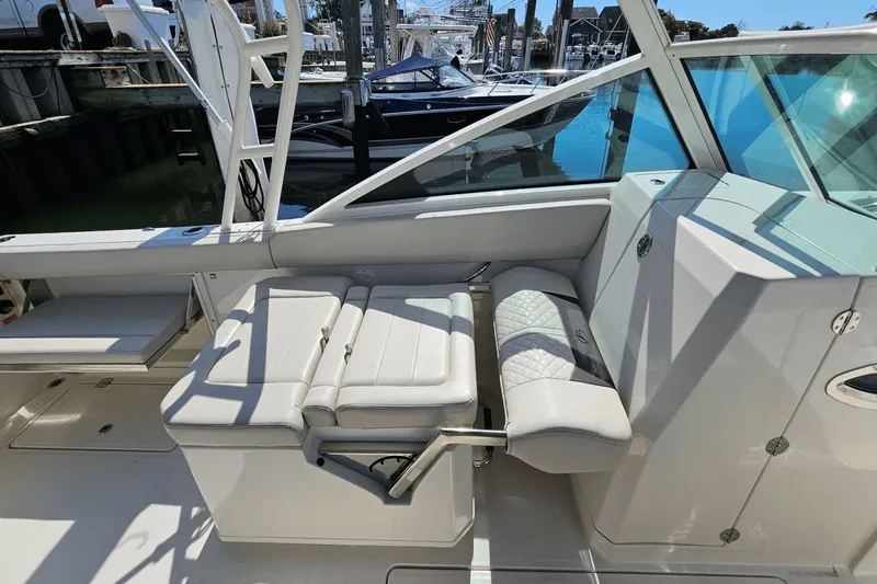  Yacht Photos Pics 2023 Sailfish 276 DC boat interior with white seating and modern design.