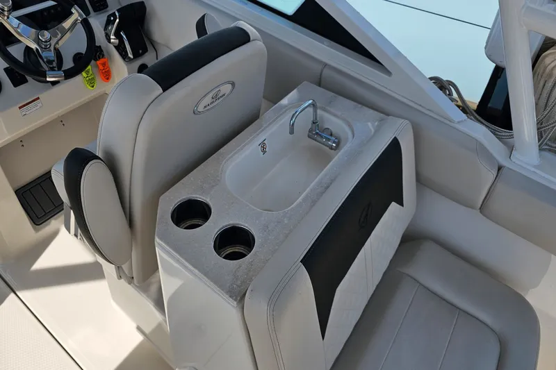  Yacht Photos Pics 2023 Sailfish 276 DC boat interior with steering wheel, sink, and cup holders.