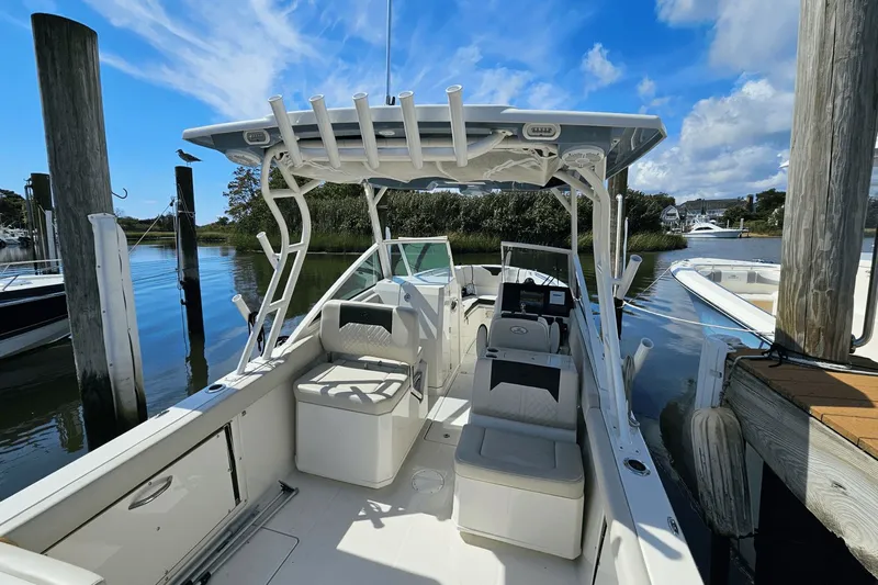  Yacht Photos Pics 2023 Sailfish 276 DC boat docked, featuring spacious seating and clear blue skies.