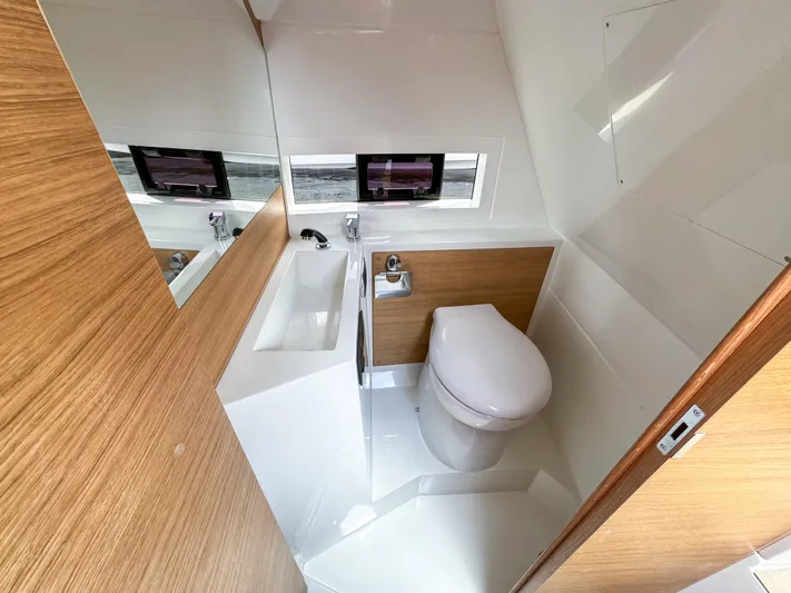  Yacht Photos Pics Bathroom interior of 2024 De Antonio Yachts D28 Cruiser, featuring modern fixtures and wood accents.