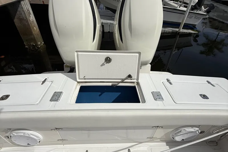  Yacht Photos Pics 2007 Jupiter 31 boat with open storage compartment and twin engines at dock.